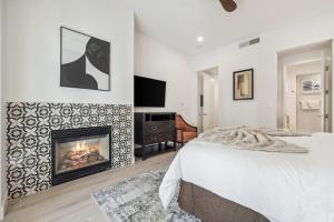 a bedroom with a bed and a fireplace at T21 Lux Villa With Fountain View Condo in La Quinta