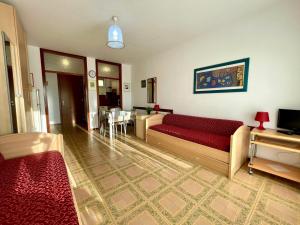 a living room with a couch and a table at Cozy studio with balcony-Beahost in Porto Santa Margherita di Caorle