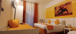 a hotel room with two beds and a painting on the wall at G&G Giusy e Gabry in Santhià