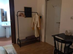 a room with a clothes rack and a sink at Tenuta Palladini 5 chilometri da porto cesario in Leverano