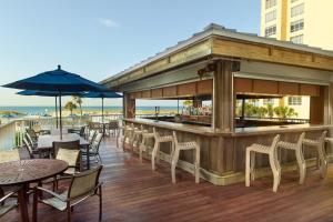 a bar on a deck with tables and chairs at SpringHill Suites by Marriott Pensacola Beach in Pensacola Beach