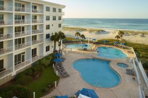 an aerial view of a hotel with a pool and the beach at SpringHill Suites by Marriott Pensacola Beach in Pensacola Beach