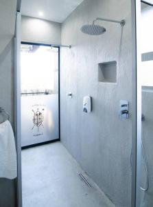 a bathroom with a shower with a glass door at Sihlangu Lodge in Marloth Park
