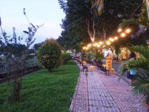 a street with a row of tables and chairs and lights at Ola's Home in Ho Chi Minh City