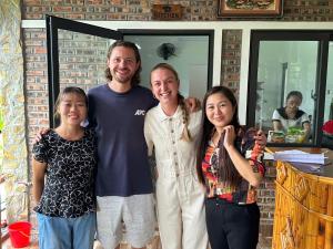 a man and his family posing for a picture at Peaceful MaiChau Homestay in Mai Chau