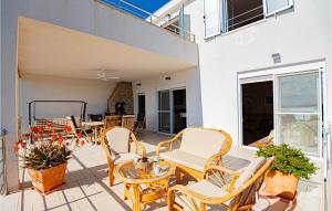 a patio with chairs and a table and a table at Awesome Home In Zaboric With Wifi in Zaboric