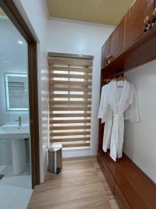 a bathroom with a white shirt hanging on a closet at Villa Mercedes Private Resort in Candon