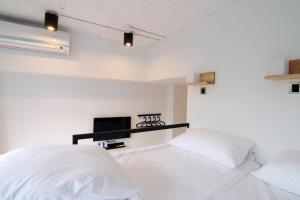 Postel nebo postele na pokoji v ubytování Taipei Sunny Hostel