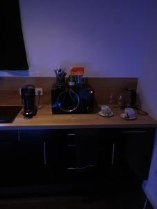 a kitchen counter with a microwave on top of it at Balnéo SPA Allevard in Allevard