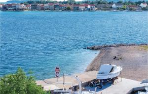 a boat on the shore of a body of water at Three-Bedroom Holiday Home In Sibenik in Šibenik