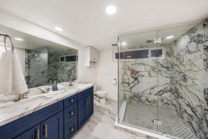 un bagno con due lavandini e una doccia di # Marbella Lane - Home with Ocean & Golf Course Views a San Clemente Altre 63 foto