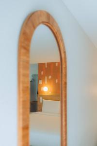 an arch mirror in a room with a bed at Kyriad Cannes - Mandelieu in Cannes