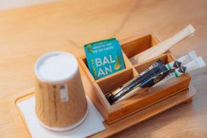 a wooden box with a book and a cup on a table at Kyriad Cannes - Mandelieu in Cannes