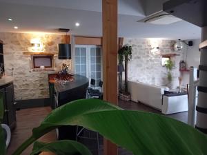 a living room with a couch and a table at Le Bel Air en Berry in Reigny +29 photos