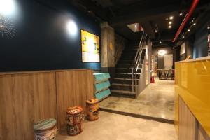 a restaurant with a staircase and a hallway with a stair case at Taipei Sunny Hostel in Taipei