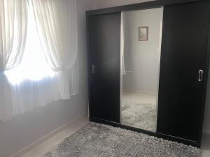 a black door in a room with a window at Recanto dos pássaros in Penha +6 photos