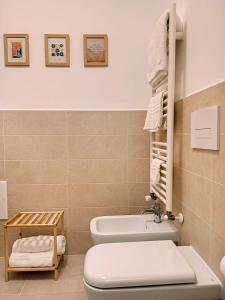 a bathroom with a toilet and a sink at Rosy Suite Bed and Breakfast in Serravalle Scrivia +182 photos