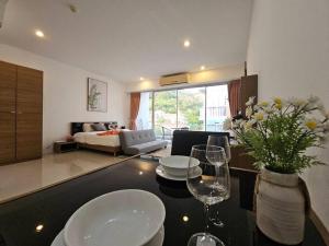a living room with two wine glasses on a table at Chic condominium karon beach in Karon Beach