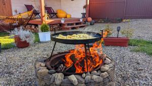 a fire pit with a bunch of food on it at "Глиняна хатинка" in Beloberëzka +40 photos