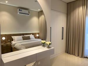 a bedroom with a bed and a large mirror at Sifah Seascape House in Muscat +32 photos