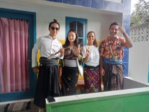 a group of people standing in front of a ping pong table at bulan homestay in Plambi