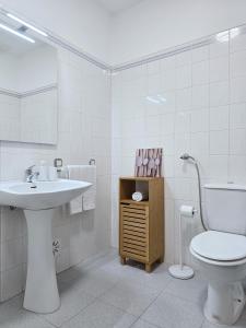 a white bathroom with a sink and a toilet at GOLDEN SUN - Sunny Balcony, Sea View, Beach, AC in Carvoeiro +32 photos