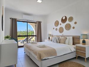 a bedroom with a large bed and a balcony at GOLDEN SUN - Sunny Balcony, Sea View, Beach, AC in Carvoeiro