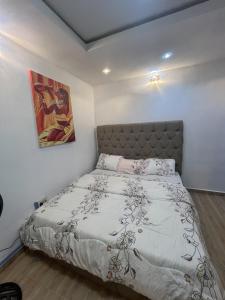 a bedroom with a bed in a white room at Memento Courts in Lagos
