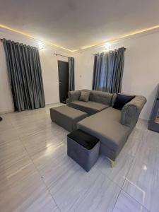 a living room with a couch and a table at Memento Courts in Lagos