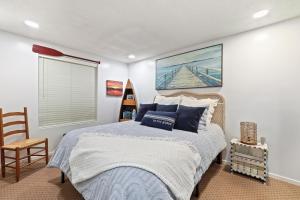 a bedroom with a bed and a chair in it at 342 Edgewater Inn in Charlevoix +15 photos