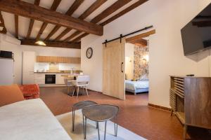 a living room with a couch and a table at Le Nostradamus - Hypercentre - Clim - Wifi in Saint-Rémy-de-Provence