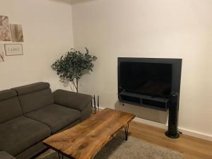 a living room with a couch and a coffee table at Schöne und sehr zentrale Wohnung im Herzen von Gelsenkirchen in Gelsenkirchen
