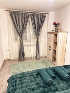 a bedroom with a large bed and a window at Green Apartment - Tomis Nord in Constanţa