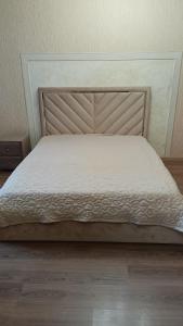 a bed in a bedroom with a white mattress at Алтын Арман in Kostanay