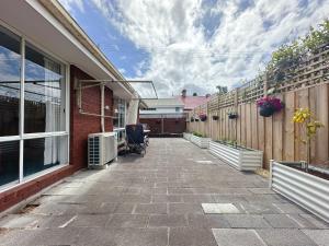 a patio of a house with a fence at Kings Corner - 5min to CBD & 20min to Airport in Sandy Bay