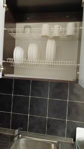 a kitchen with plates and dishes on a shelf at Алтын Арман in Kostanay +2 photos