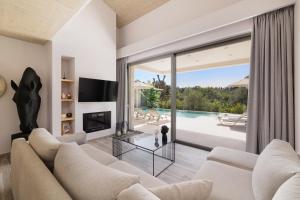 a living room with a couch and a fireplace at My Mediterranean Luxury Villas,Corfu in Kontokali