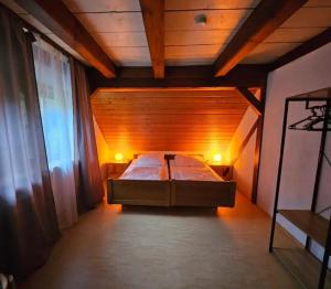a bedroom with a bed in a wooden room at Ferienhaus Auszeit in Seebach +21 photos