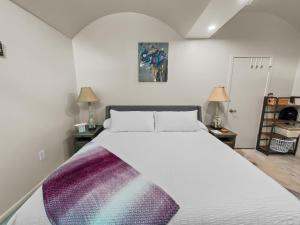 a bedroom with a large bed with a colorful blanket on it at Quiet Garden Sanctuary home in Clifton