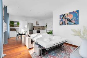 ein weißes Zimmer mit einem Bett und einer Küche in der Unterkunft Milan Stay - Porta Venezia View in Mailand