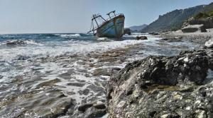 a boat sitting on a beach near the water at BhC in Agios Gordios +9 photos