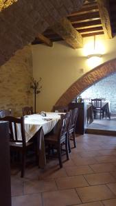 a dining room with a white table and chairs at Dimora Fra' Giovanni B&B Relais in Magione