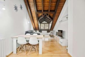 a dining room with a white table and white chairs at LINA by Cardi Suites in Escarrilla