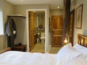 a bedroom with a bed and a bathroom at Fife Country Escapes in Cupar