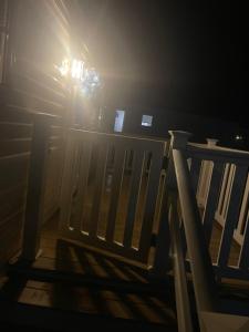 a person standing next to a wooden fence in the dark at 25 cherry tree in Gristhorpe