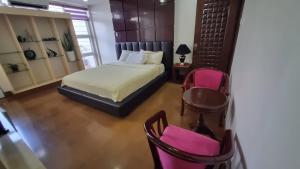 Postel nebo postele na pokoji v ubytování Baguio Brentwood Villas