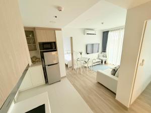 a kitchen and living room with a couch and a table at Skypark Laguna Phuket in Bang Tao Beach