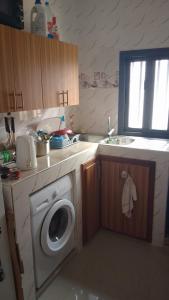 a kitchen with a washing machine and a sink at Oasis appartements in Keur Massar