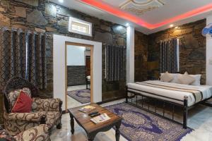 a bedroom with a bed and a couch and a table at Emperor Palace A Heritage villa in Udaipur +15 photos