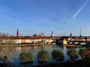 a view of a city with a river and buildings at Wohnen am Main in Würzburg
